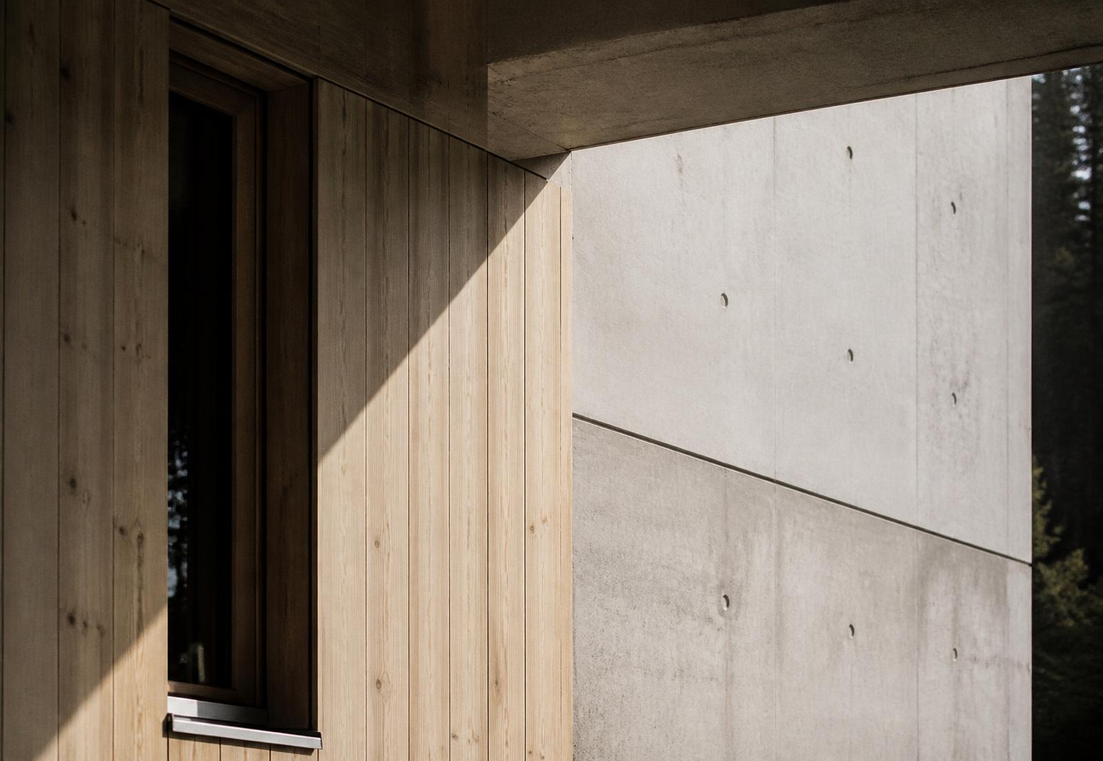Opening sequence — light moving across a concrete and timber facade